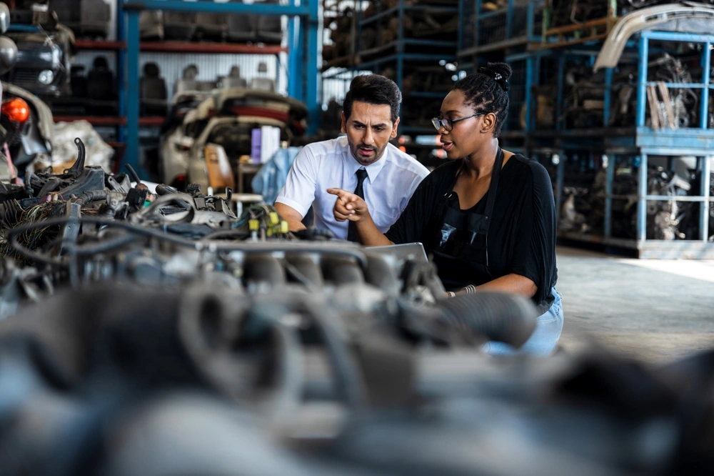 Two men looking at auto parts